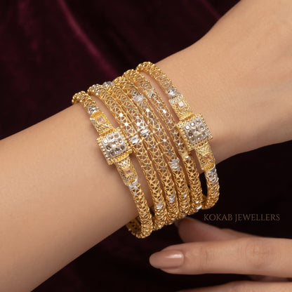 Textured gold filigree bangles with ruby stone clasps worn on wrist - KOKAB Jewellers wedding kangan