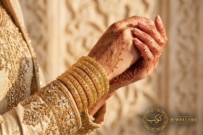 Golden diamond cut bangles on henna hand - slim kangan set Pakistan