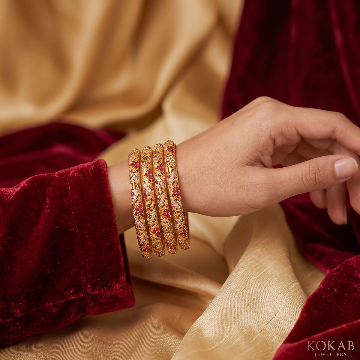 Gold kundan bangles with ruby stones worn with bridal outfit - KOKAB Jewellers wedding kangan