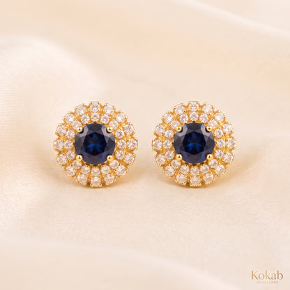 Pair of royal blue floral halo stud earrings with gold plating and cubic zirconia