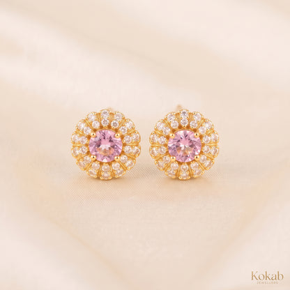 Pair of blush pink floral halo stud earrings with gold plating and cubic zirconia