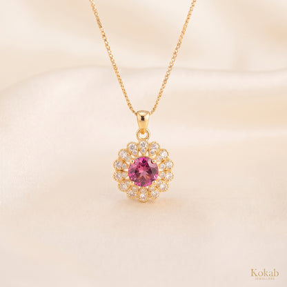 Close-up of gold plated blush pink floral halo pendant necklace with sparkling zirconia stones