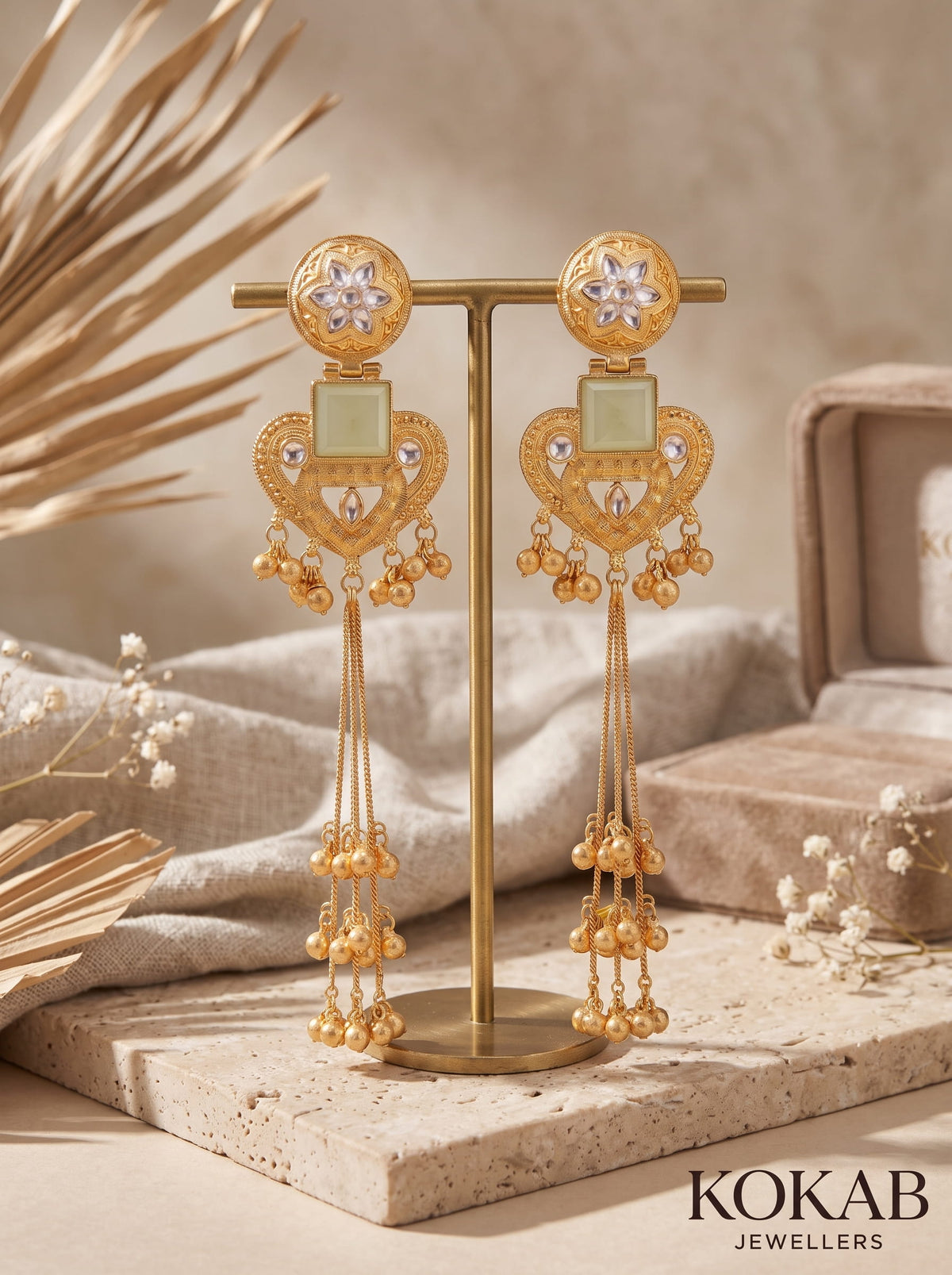 White Kashmiri long dangles with heart and floral gold-finished filigree and cascading ghungroo bells.