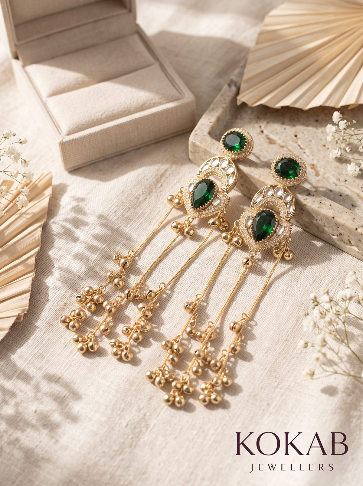 Emerald green Kashmiri long dangle earrings featuring Kundan work and cascading ghungroo tassels.