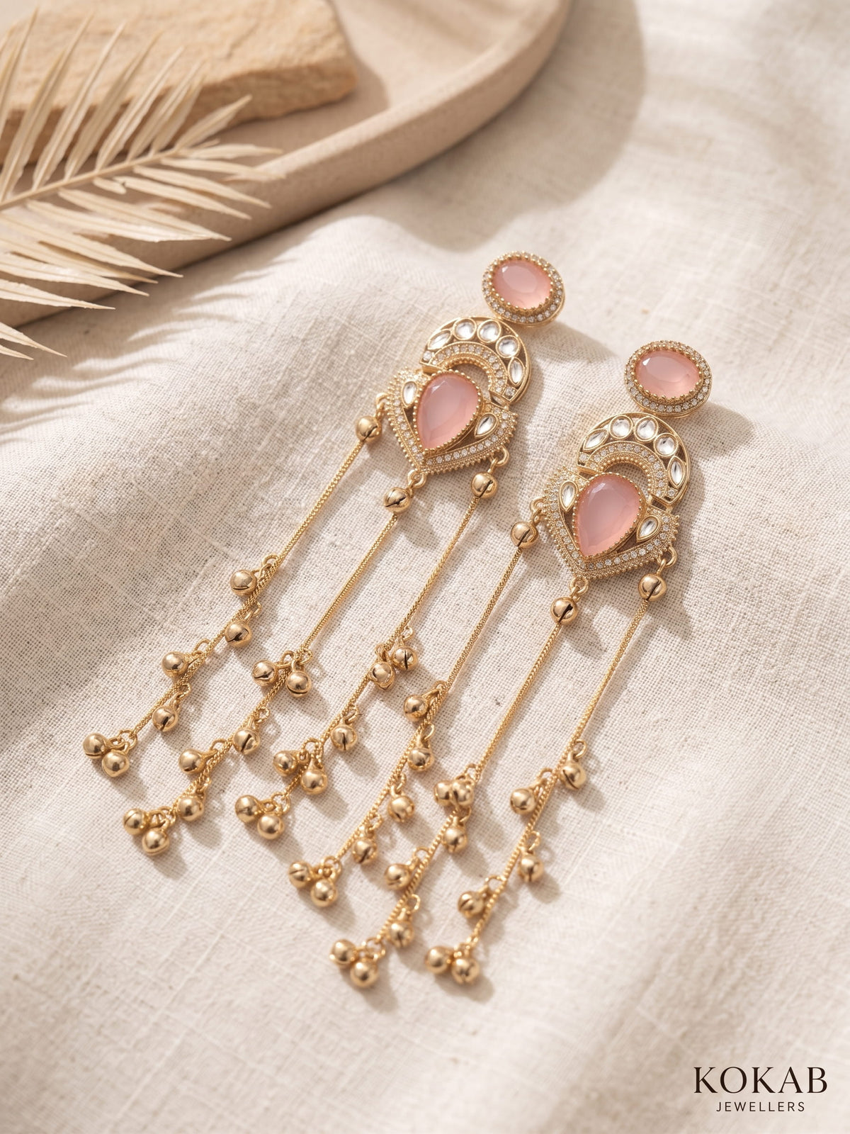 Blush pink Kashmiri long dangle earrings featuring Kundan work and cascading ghungroo tassels.