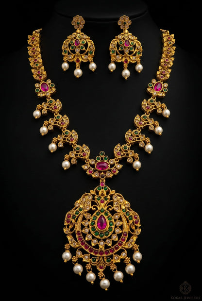 Peacock ruby long necklace set with pearl drops on black background