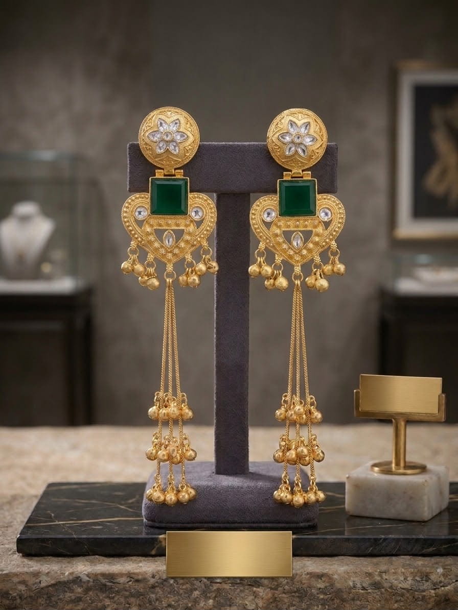 Green Kashmiri long jhumka earrings with kundan, floral borders, and cascading ghungroo bell tassels.