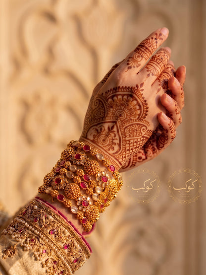 Ruby medallion gold bangles worn on henna wrist - bridal kangan set Pakistan