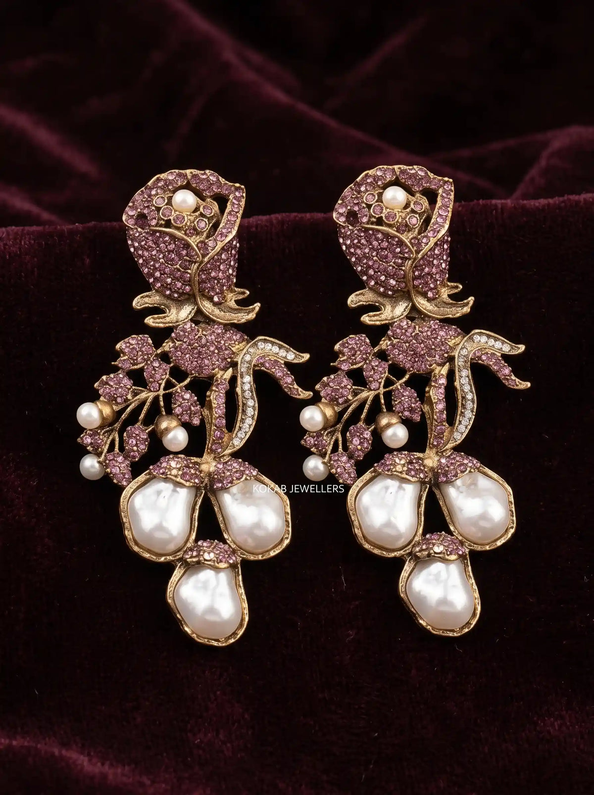 Mauve pink rose earrings with baroque pearl drops and pearl buds on maroon velvet
